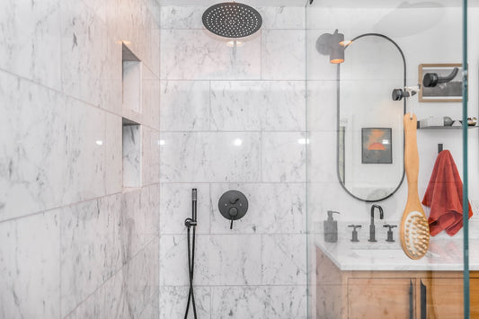 Black rain shower head on white ceramic wall tiles — rain shower vs regular showerhead